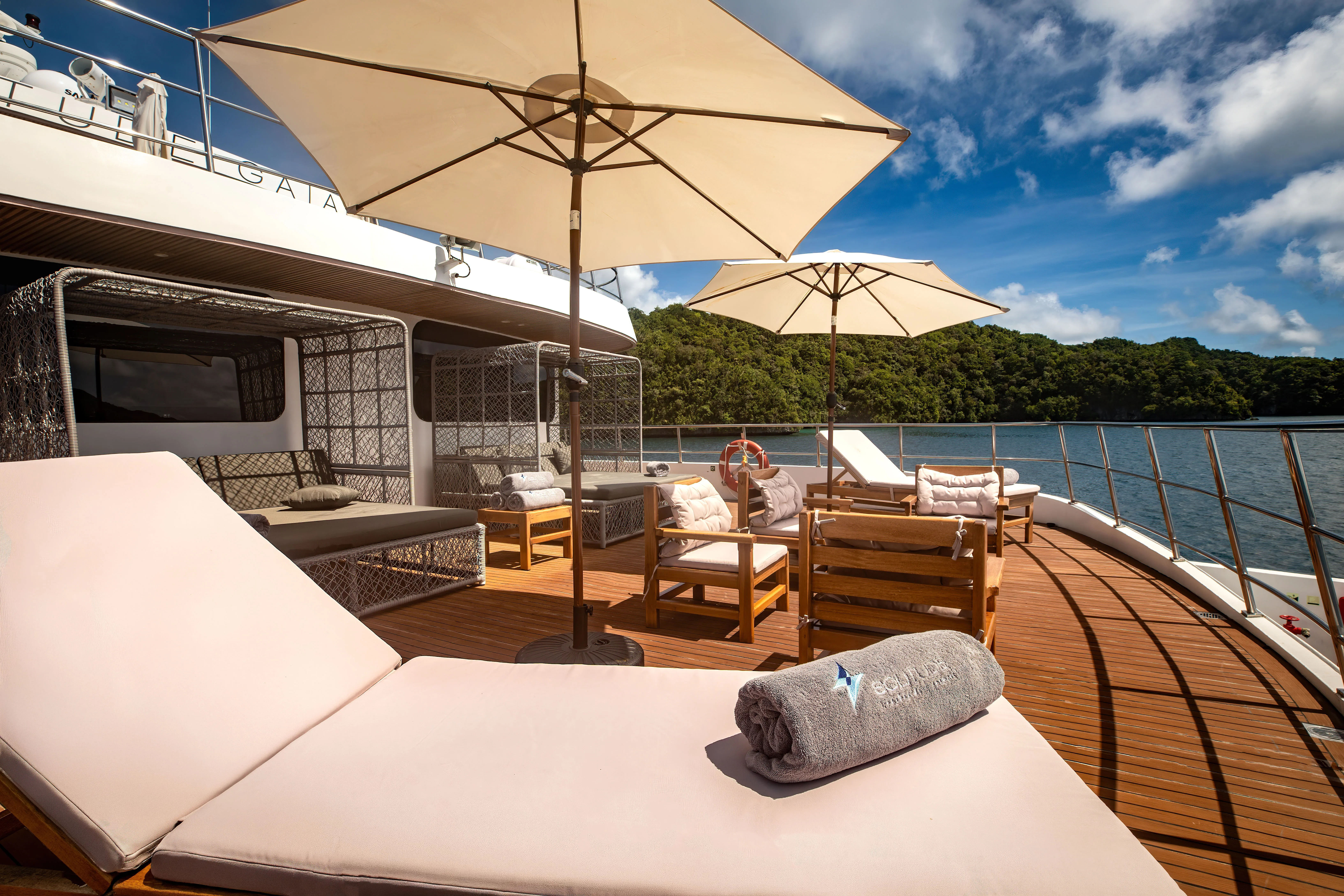 Deck loungers on Solitude Gaia looking out over the jungle of Palau