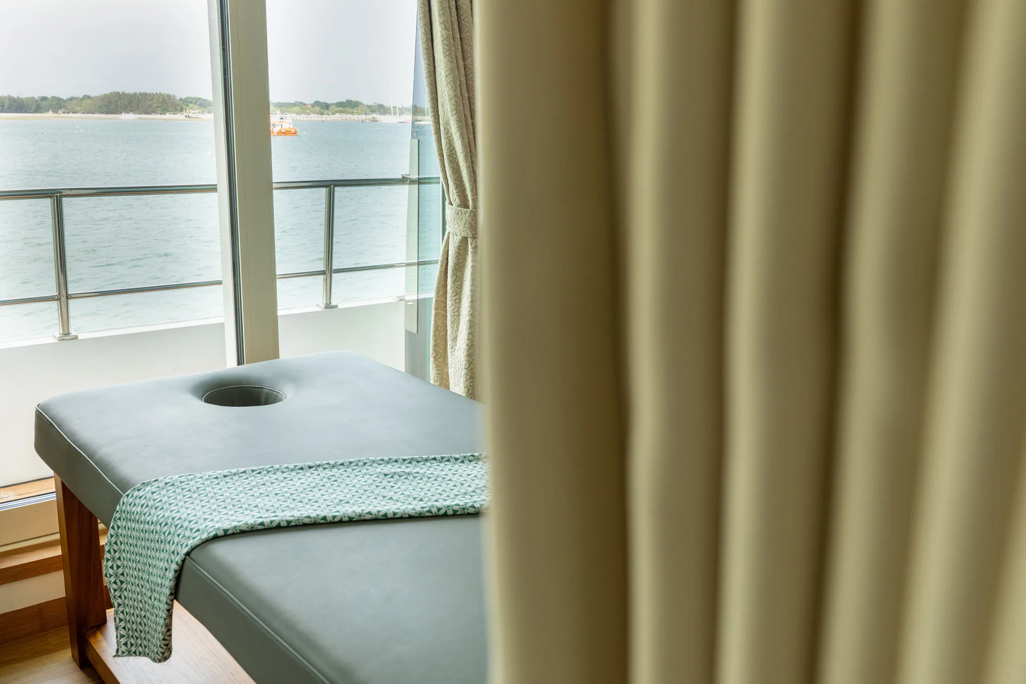 Massage bed on Solitude Gaia with a view over the water