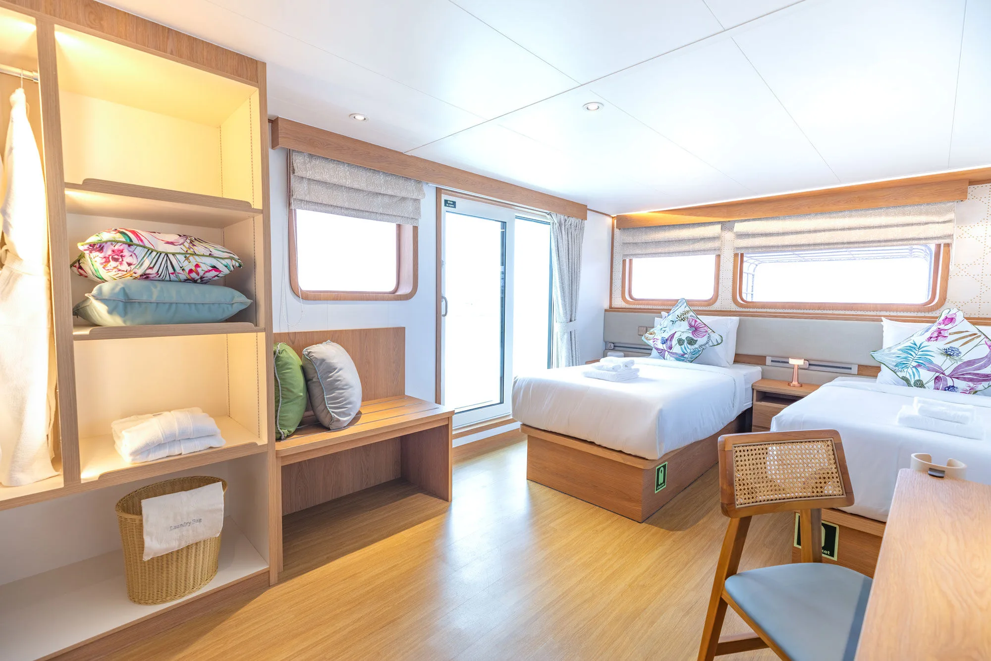Stateroom on Solitude Gaia — shelving, bench and deck access