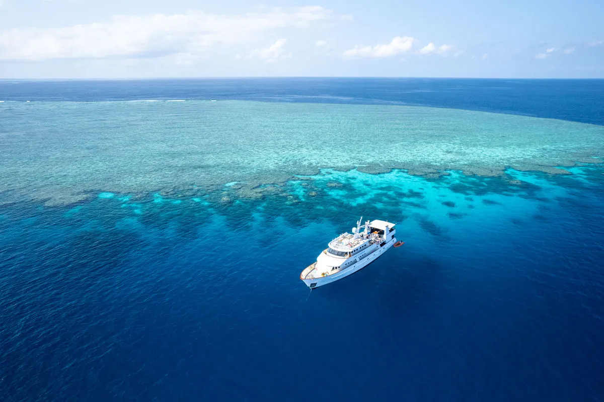 Spirit of Freedom alone in open blue beside the reef