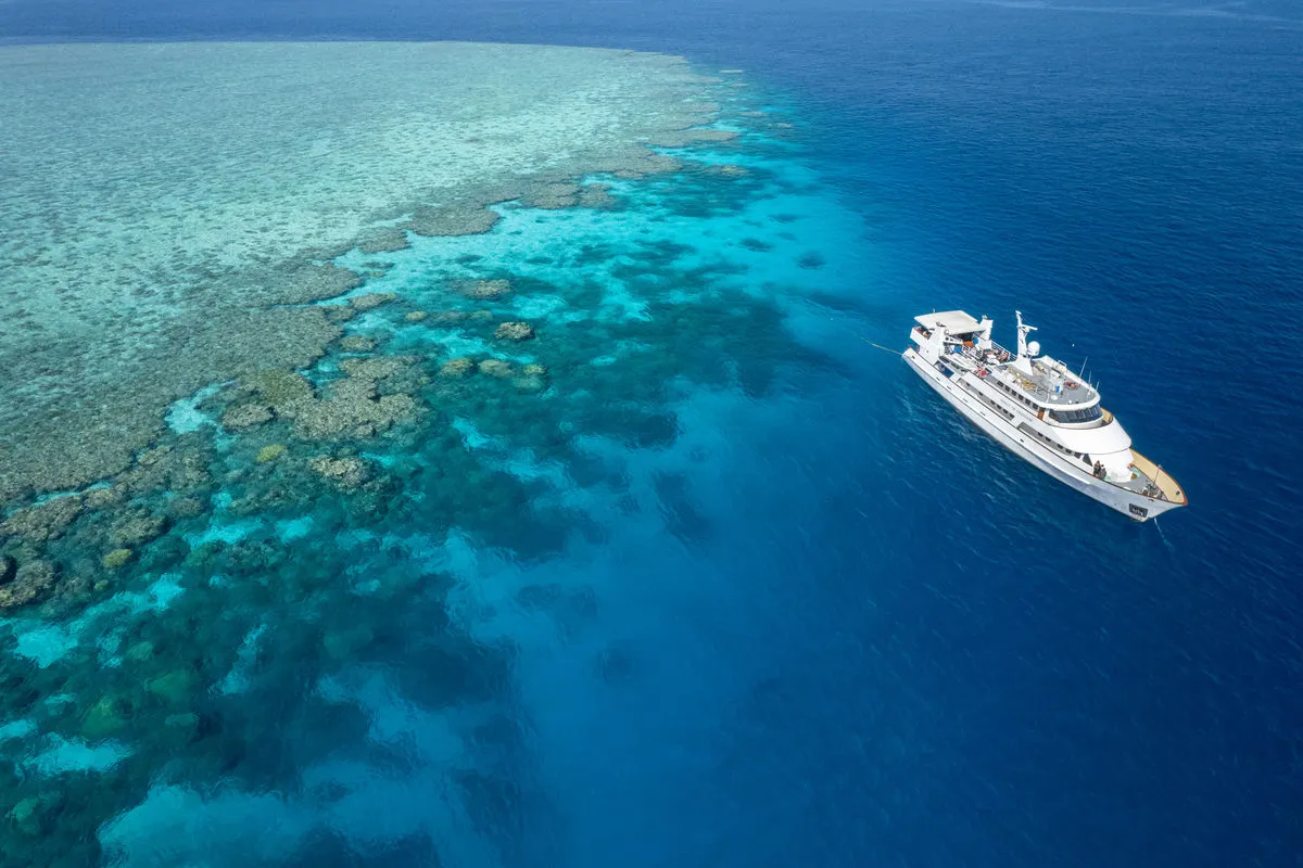 Spirit of Freedom next to a large reef system, seen from the air