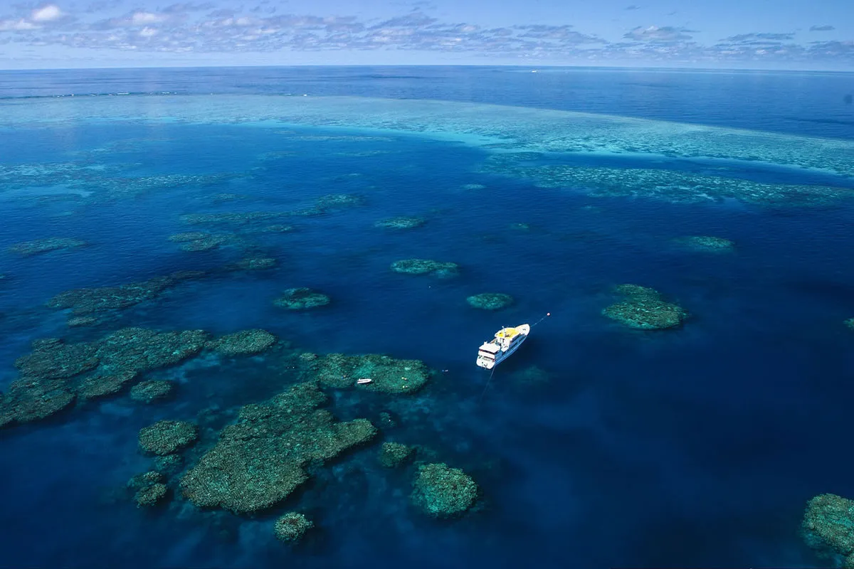 The pattern of the Ribbon Reefs from the air with the vessel at anchor