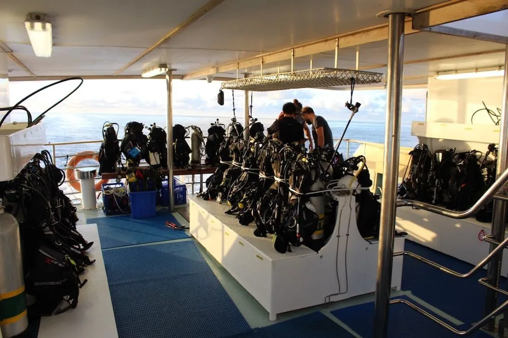 The dive deck of Spirit of Freedom with cylinders and BCDs in their racks