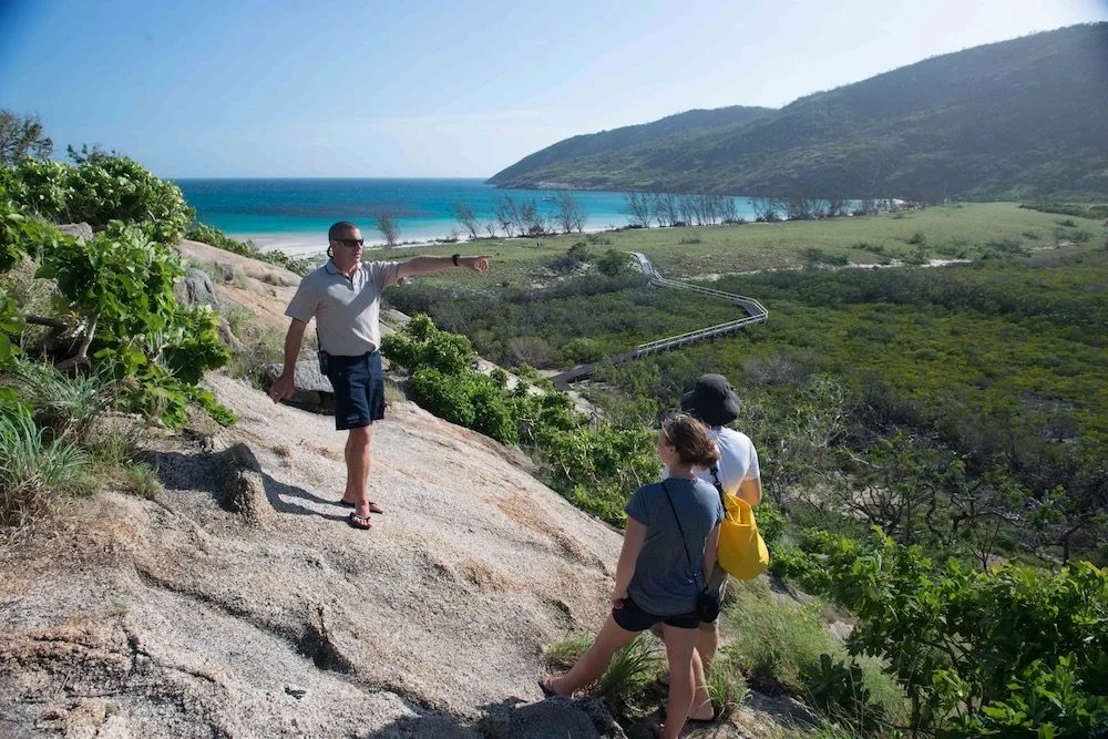 Walking down from the Lizard Island hills to the white sand beach