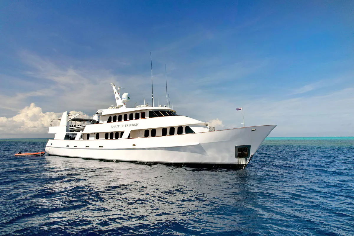 Spirit of Freedom moored over a shallow coral reef