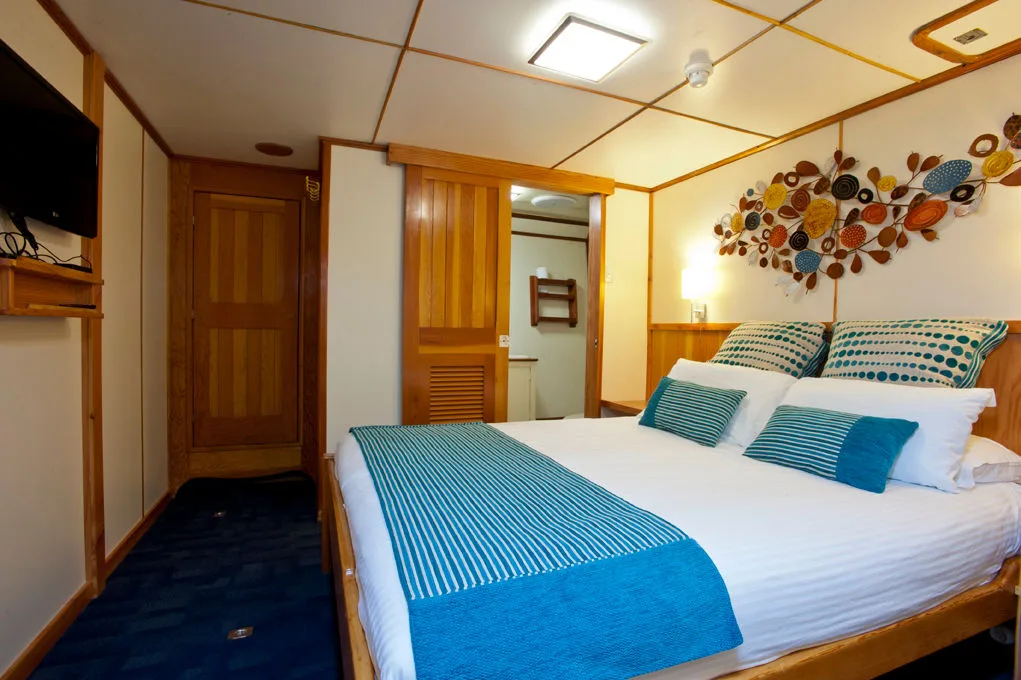 Stateroom on Spirit of Freedom — queen-size bed in the vessel's largest cabin
