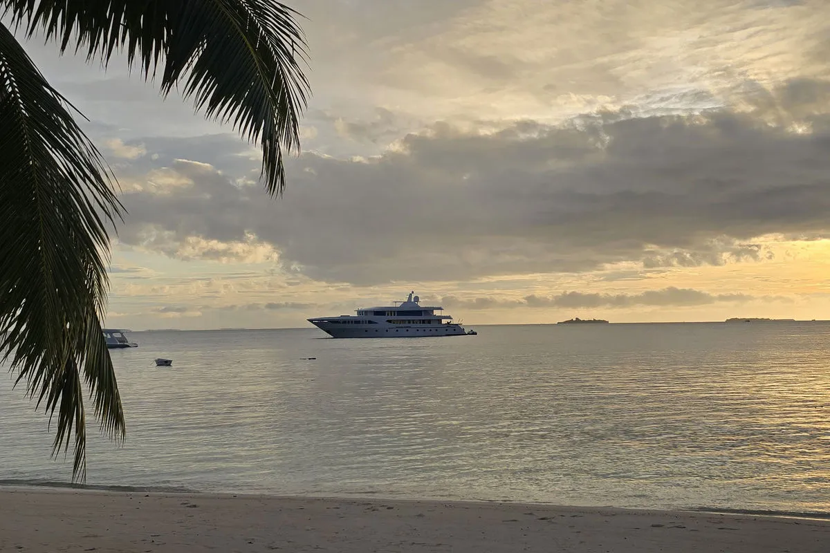 Spirit of Maldives at sunset seen from a sandy beach