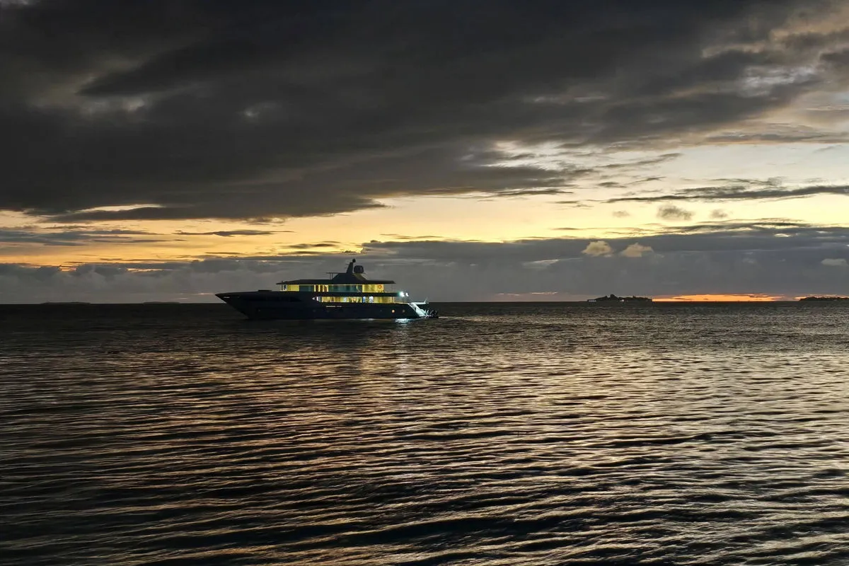 Spirit of Maldives at night — lit decks above the water