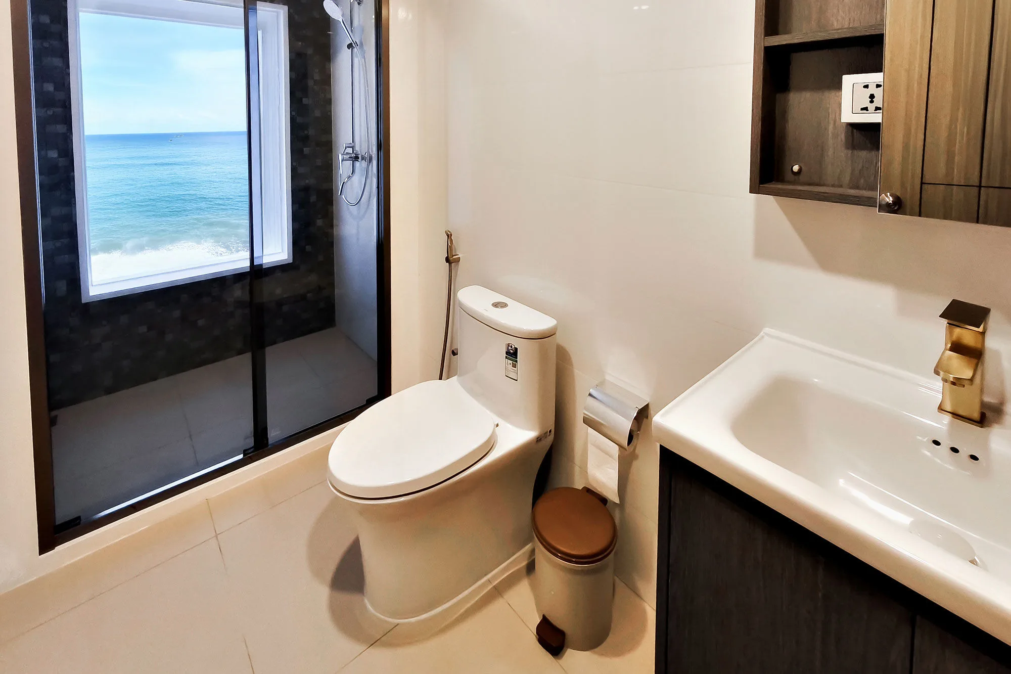 Cabin bathroom on Spirit of Maldives — shower with an ocean-view window
