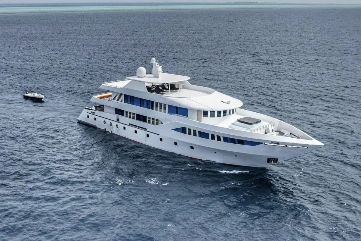 Spirit of Maldives from the air with the dive dhoni alongside