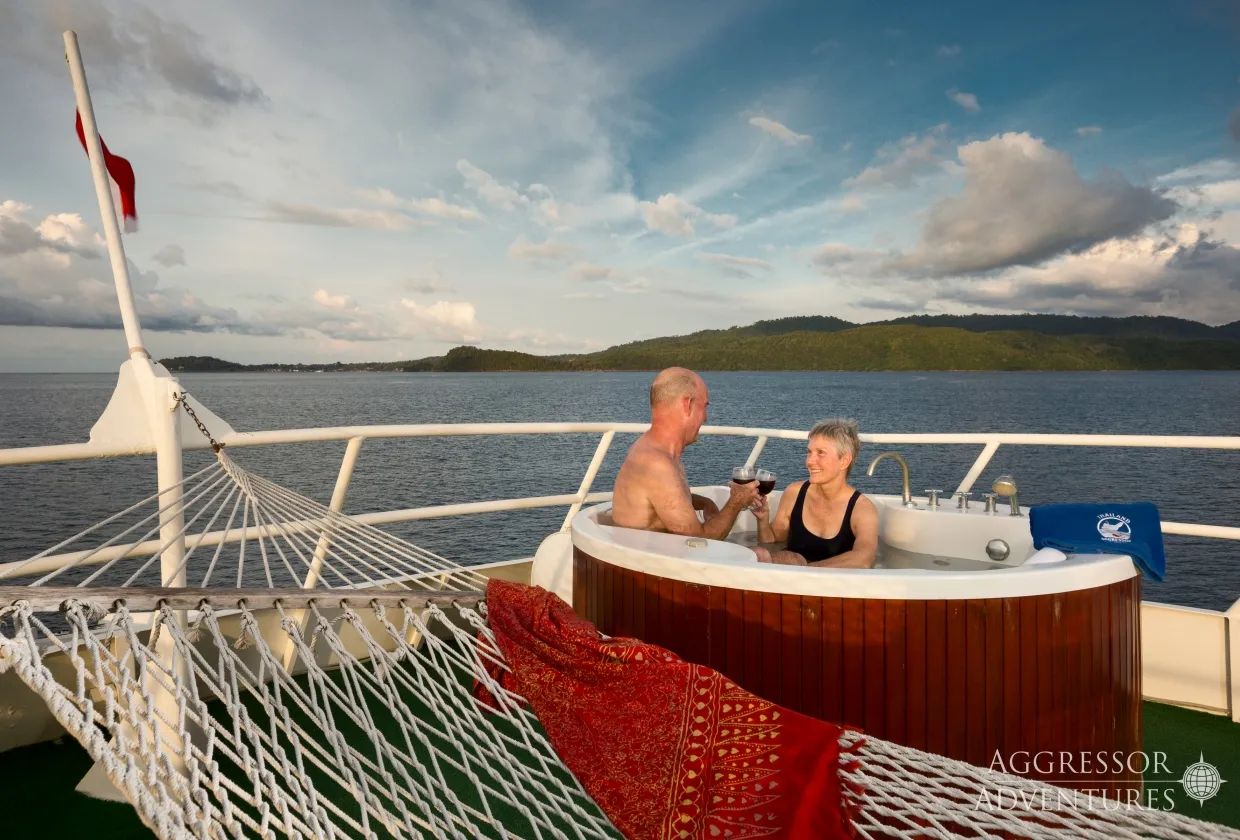 Guests in the hot tub of Thailand Aggressor with an island view