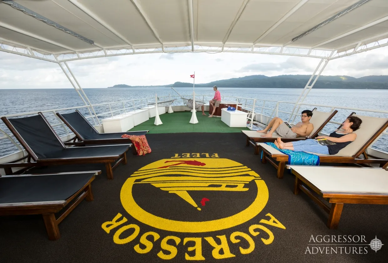 Sun deck of Thailand Aggressor with loungers and the fleet emblem