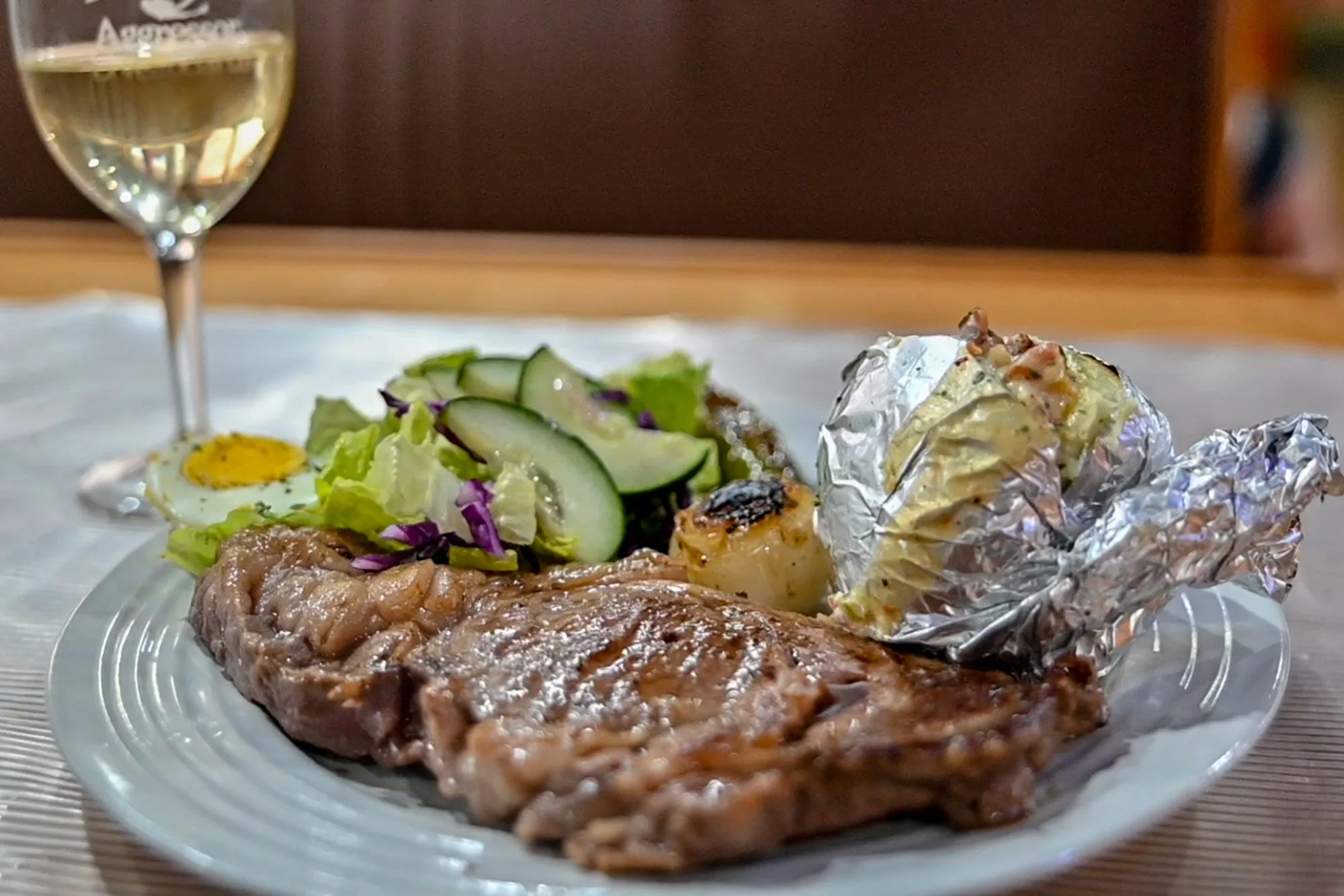 Steak with vegetables and a glass of wine on Thailand Aggressor