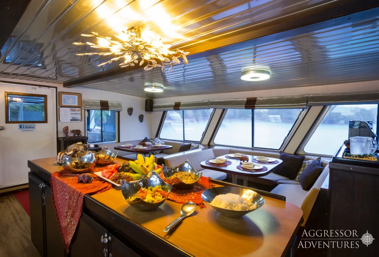 Dinner on Thailand Aggressor — set tables under the chandelier