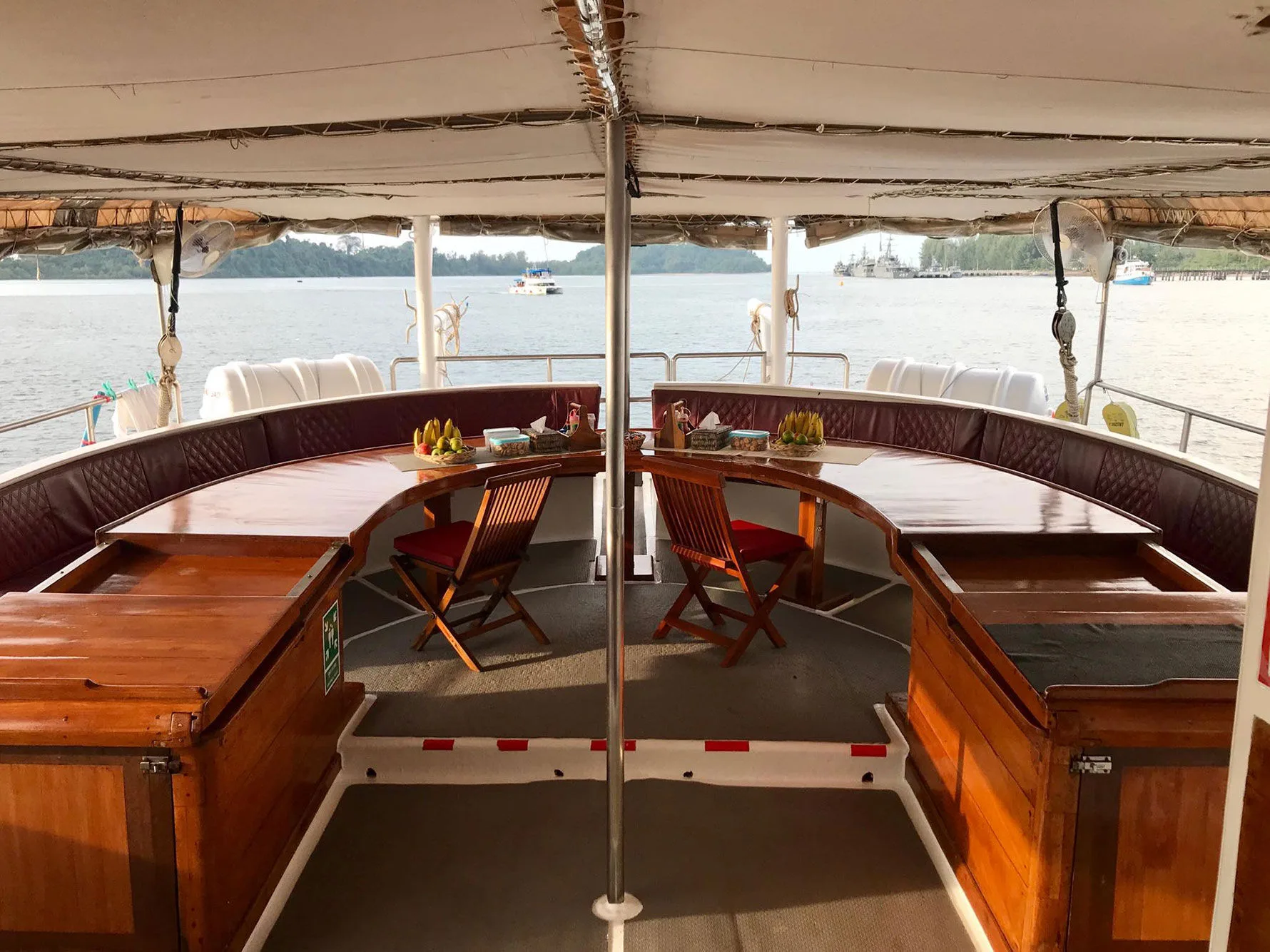 The covered aft dining area of Thailand Master looking out over the islands