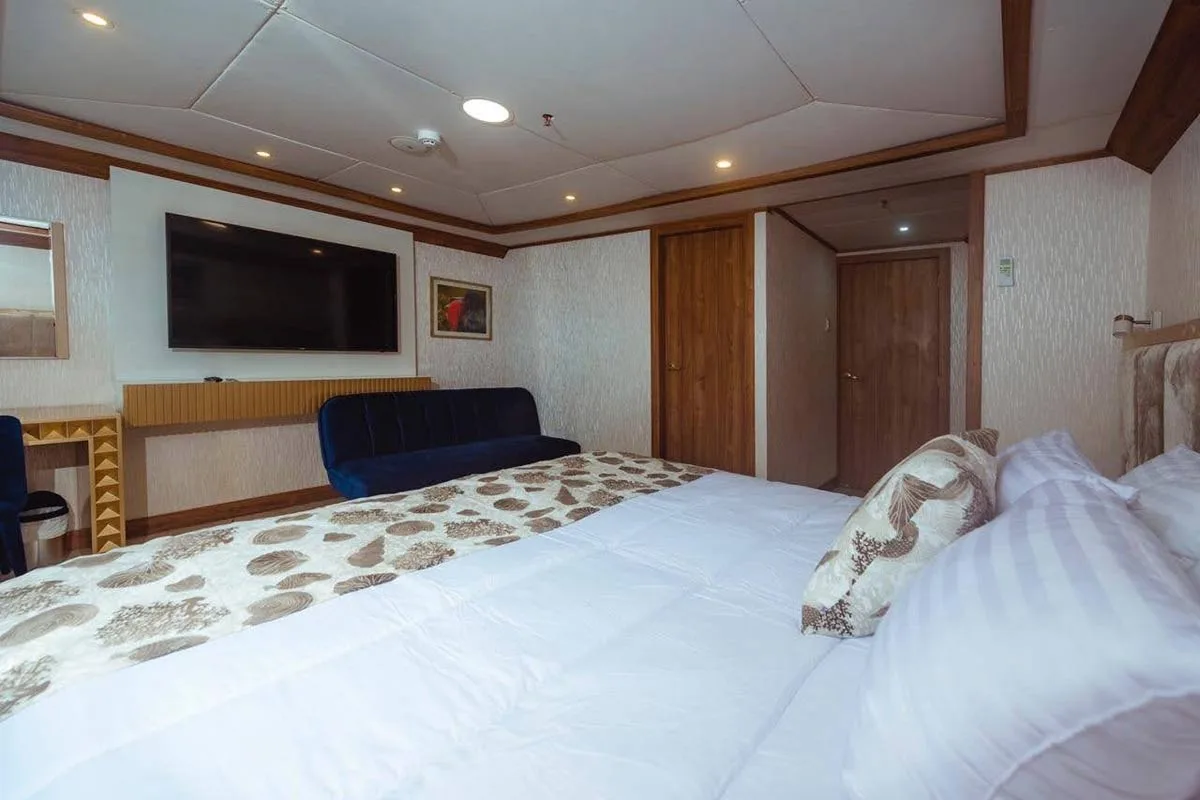 Lower deck cabin on Tiburon Explorer with a wide bed