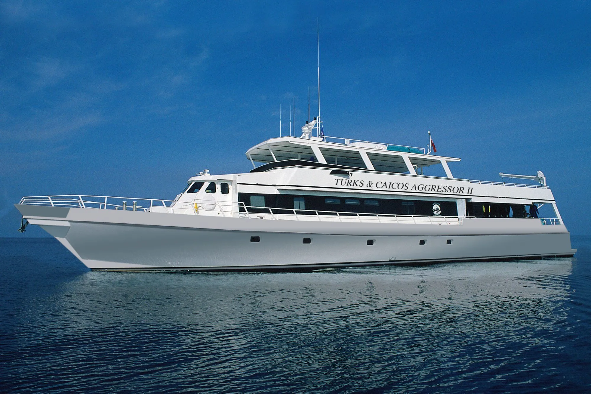 Turks and Caicos Aggressor II side on in open water with her name on the hull
