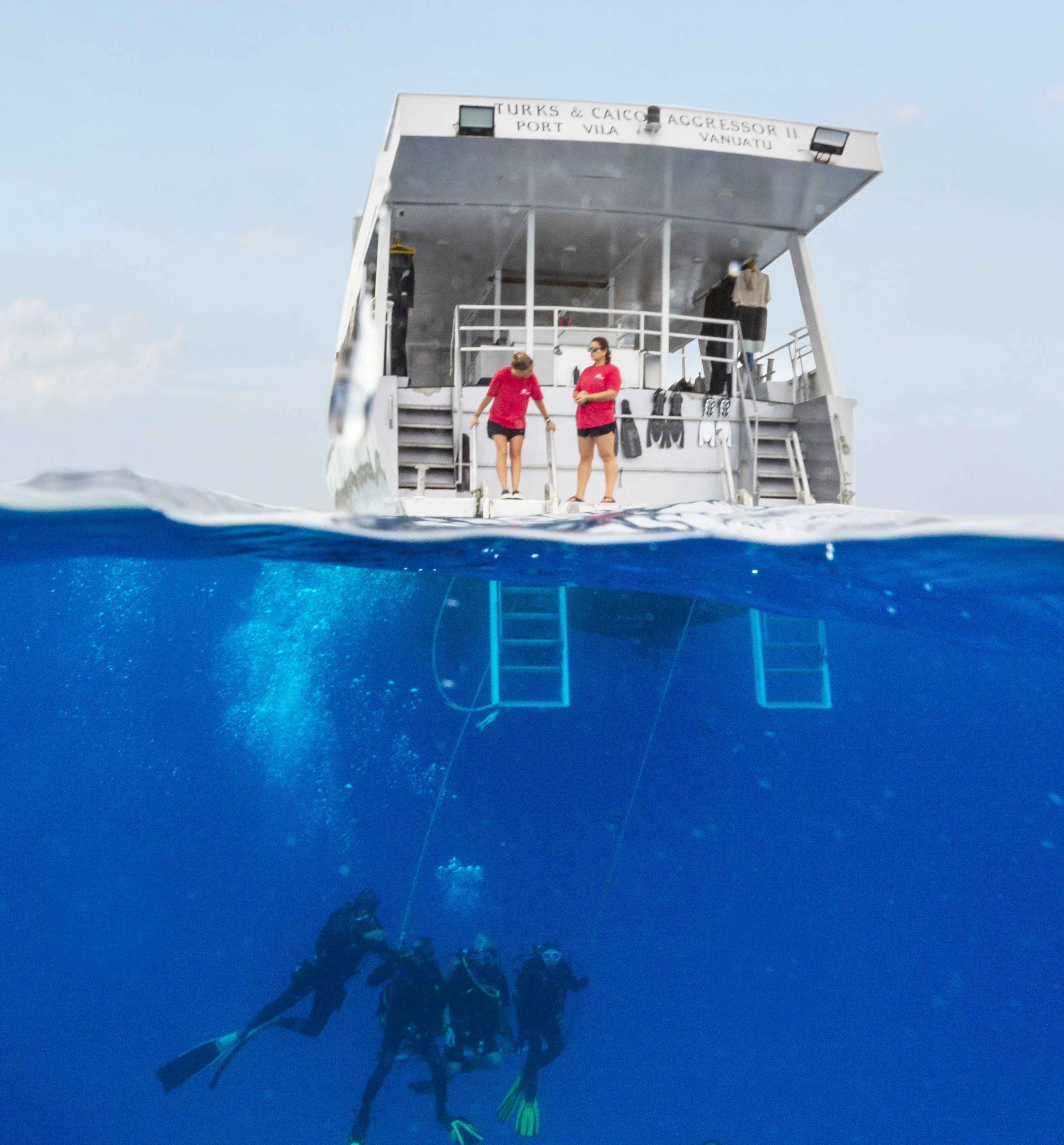 Split-level view at the stern as divers descend beneath the platform