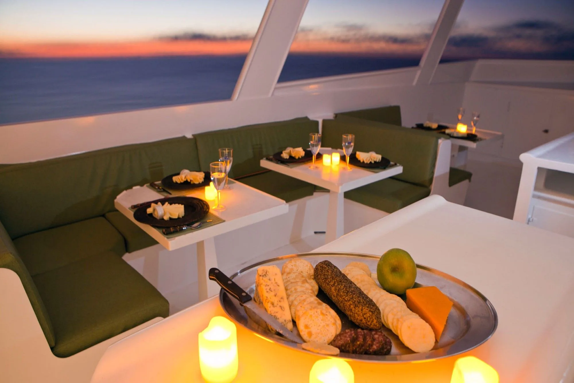 Candlelit dinner on the open deck of Turks and Caicos Aggressor II at sunset