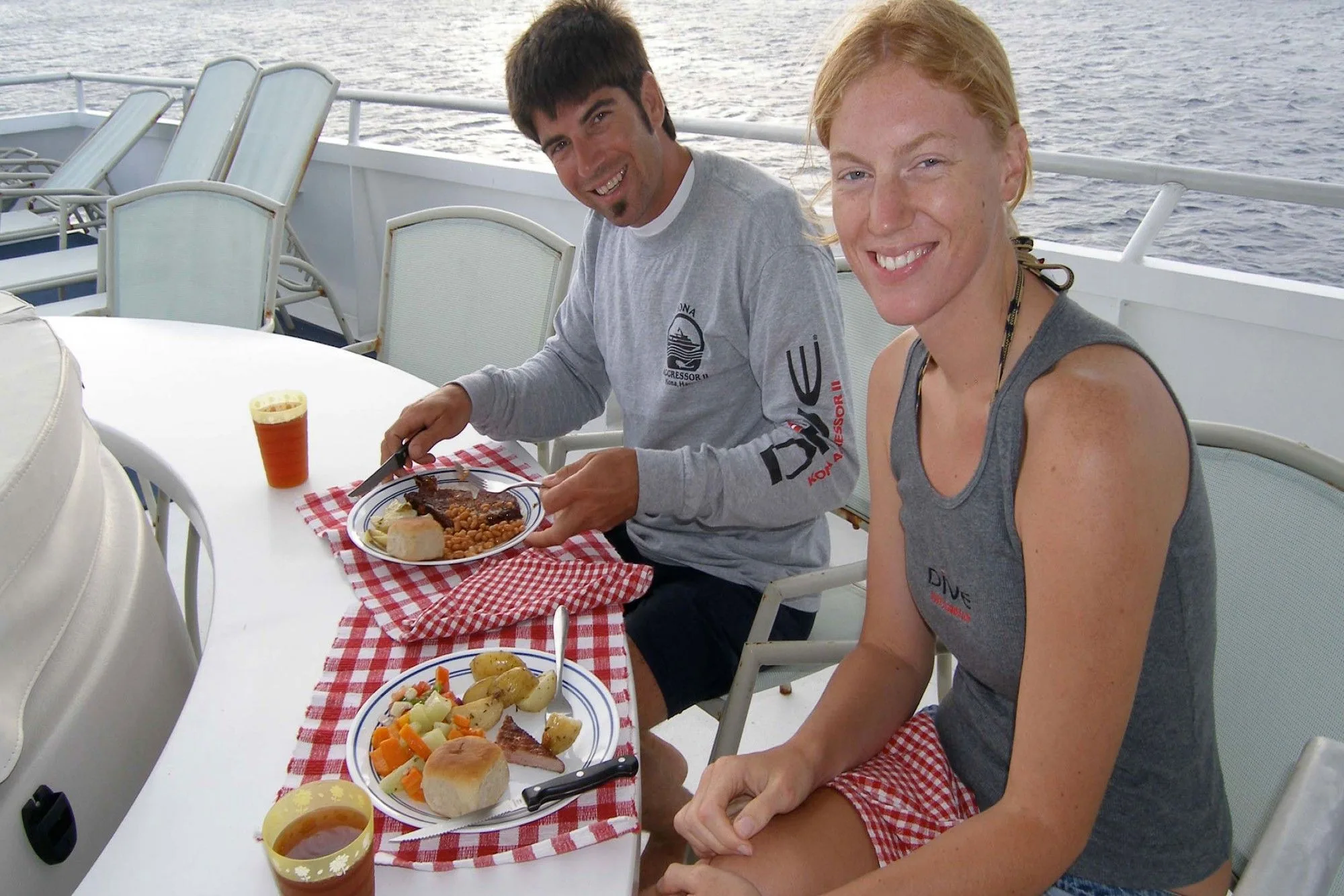 Guests eating at a table on the aft deck