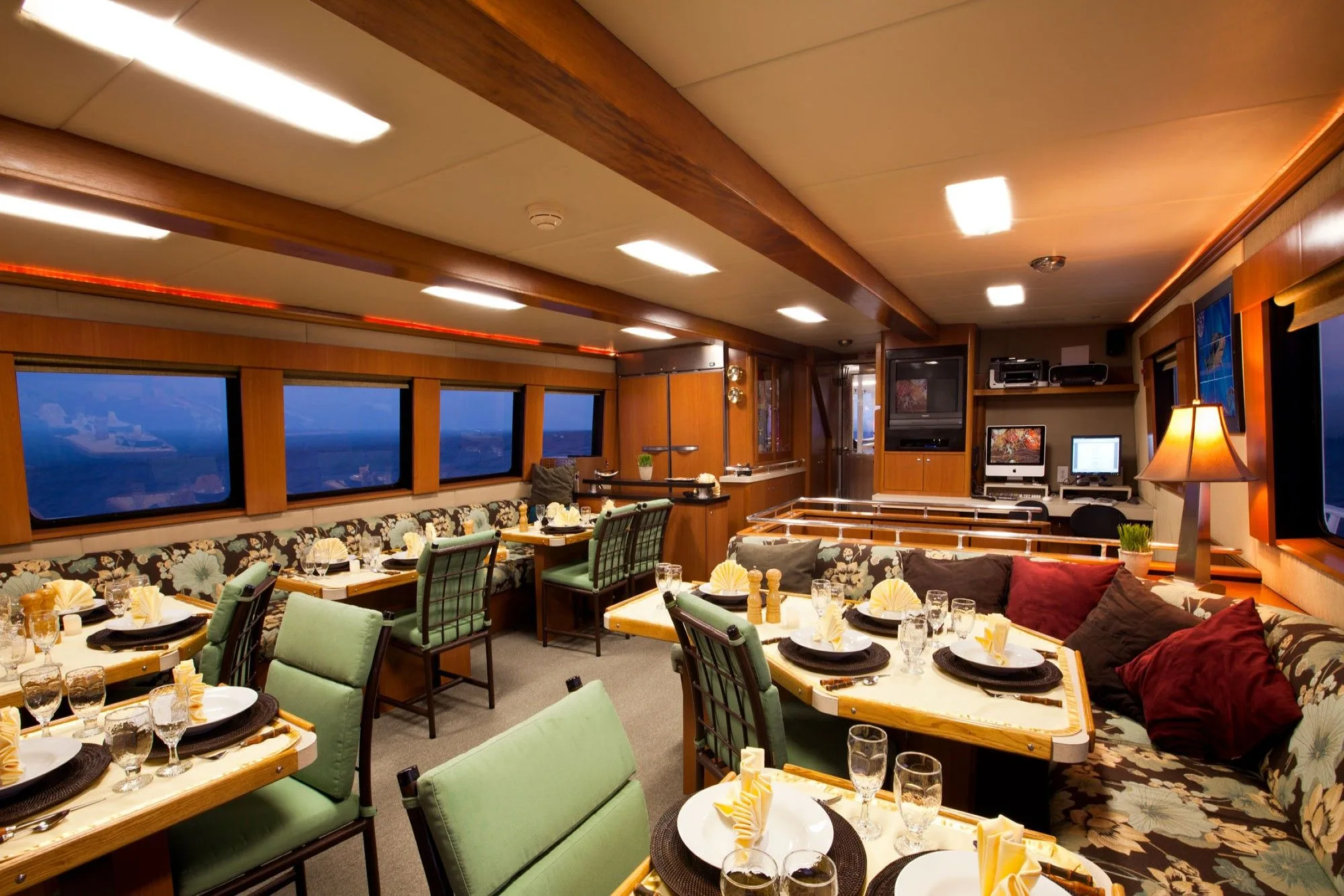 Salon and dining area of Turks and Caicos Aggressor II with tables laid