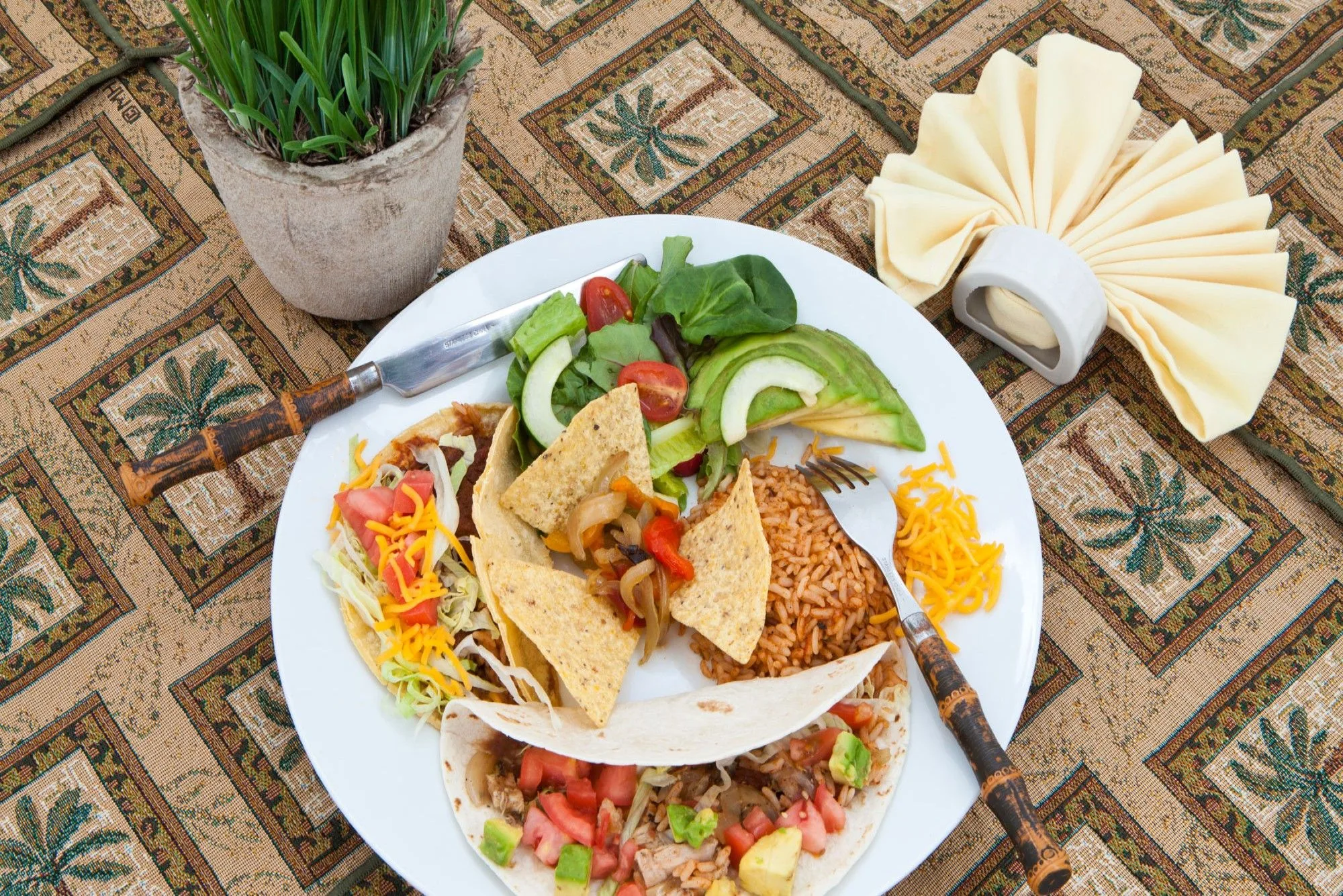 Lunch buffet plate with tacos, salad and Mexican rice