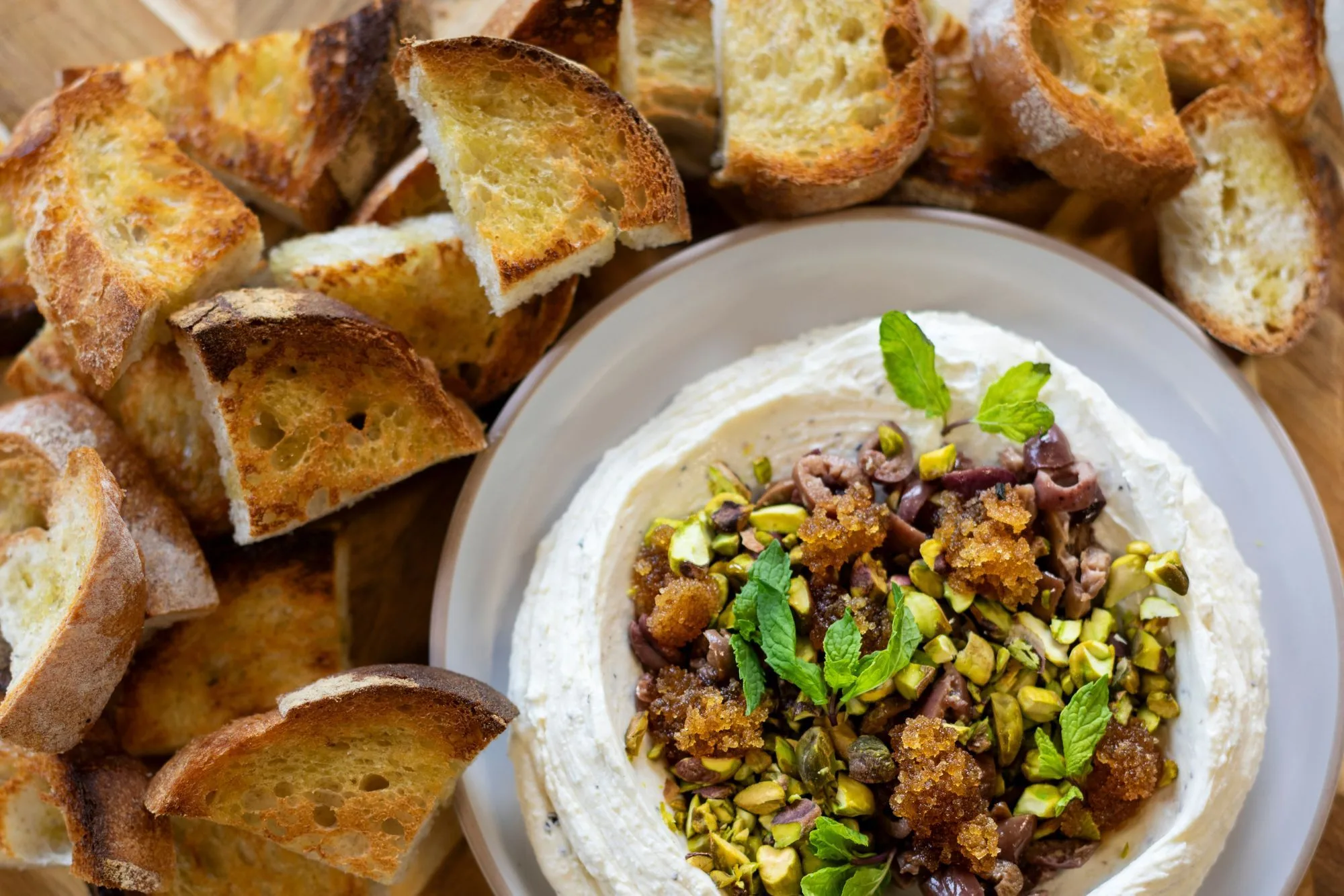 Whipped feta with pistachio and crisp bread served as a starter