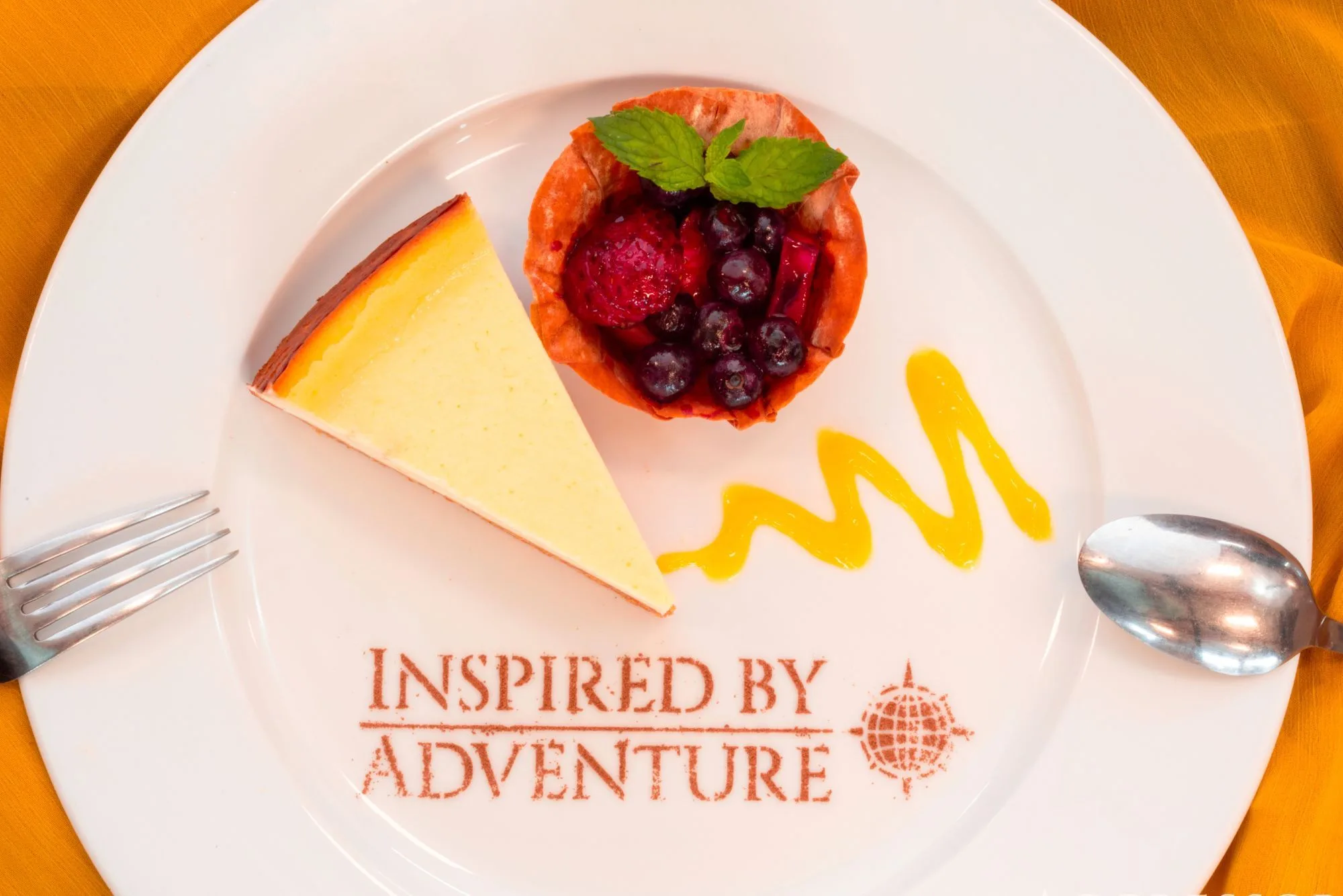 Dessert on an Aggressor plate reading Inspired by Adventure