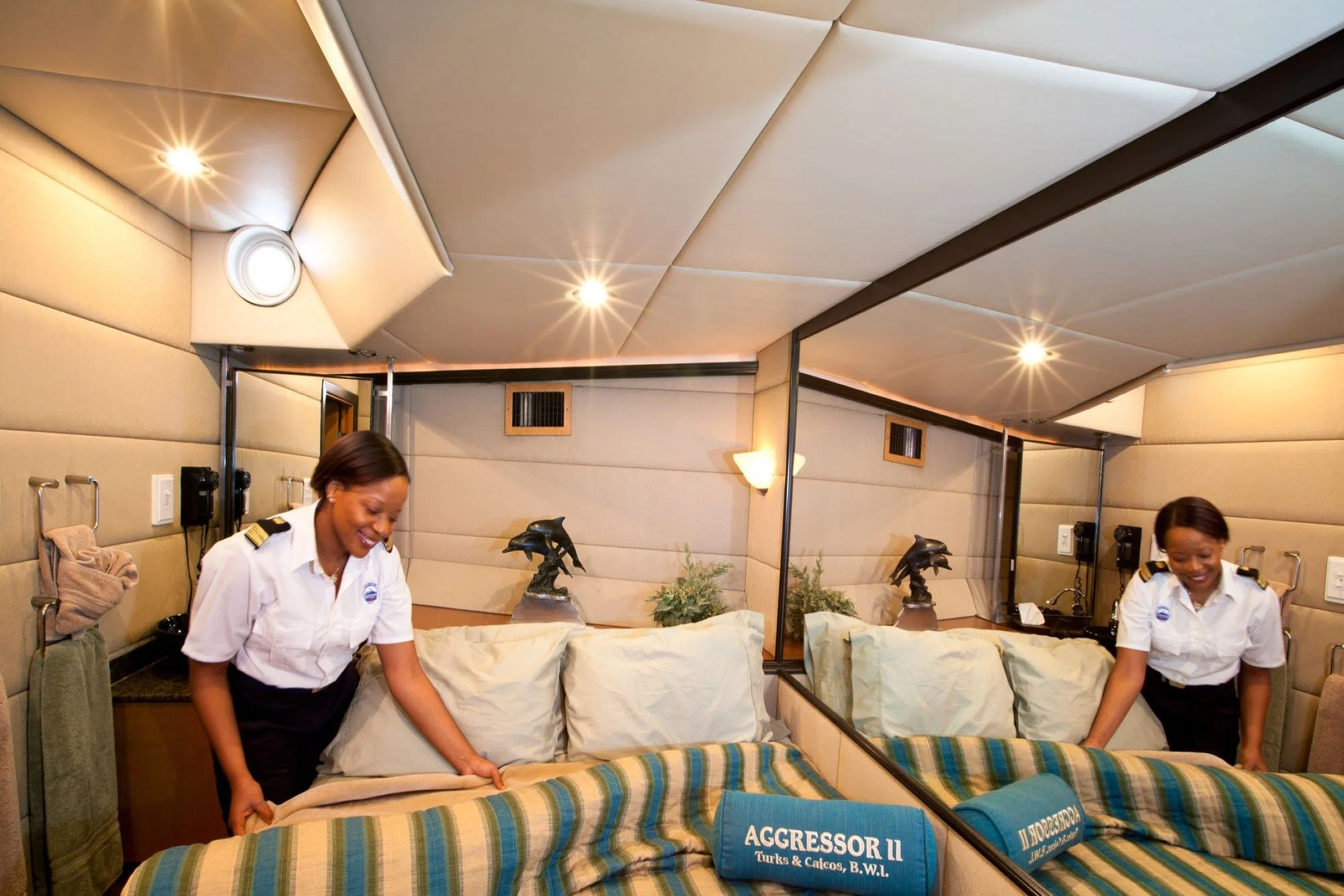 Stewardesses making up the master stateroom bed on Turks and Caicos Aggressor II