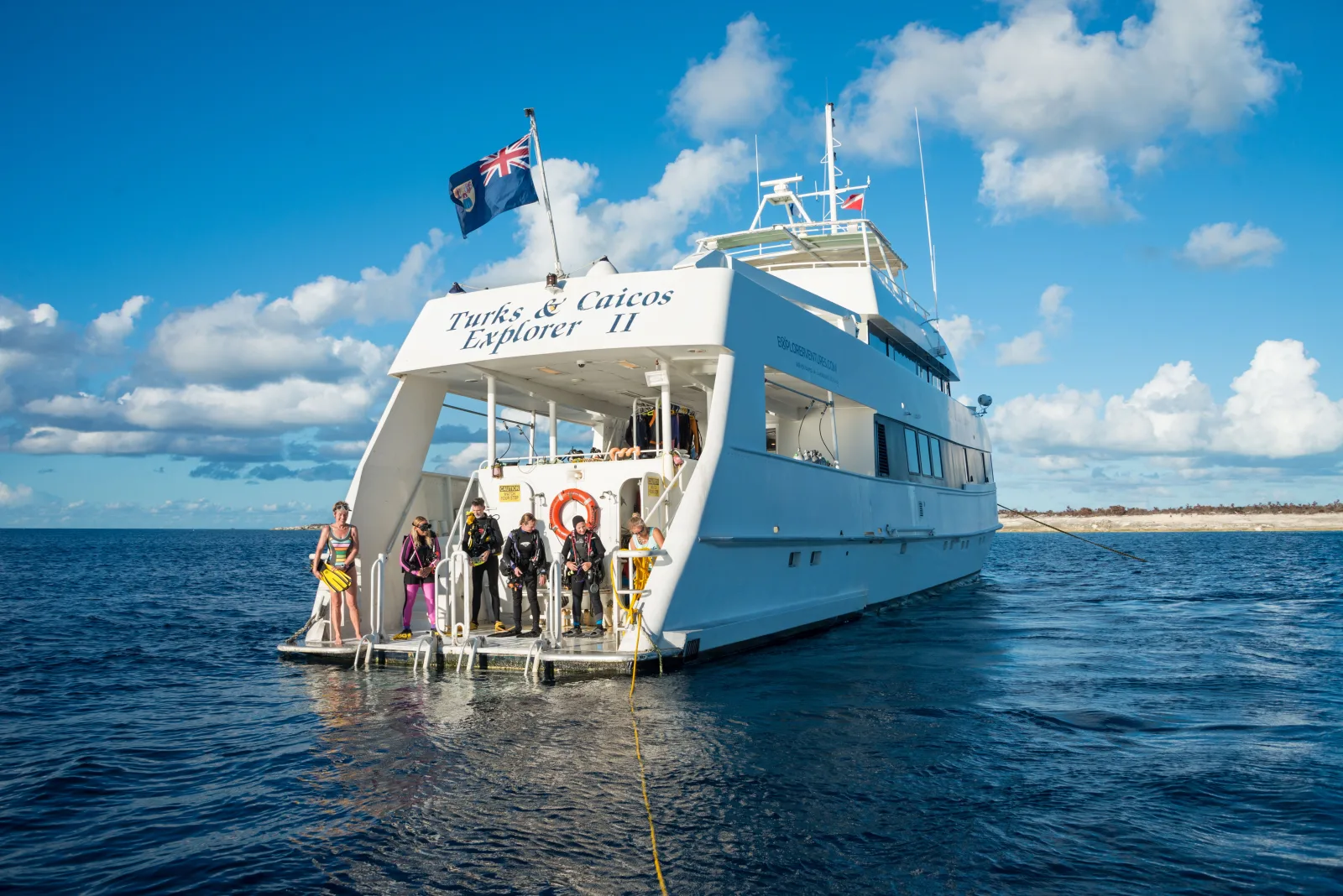 Divers on the stern platform of Turks & Caicos Explorer II before a dive