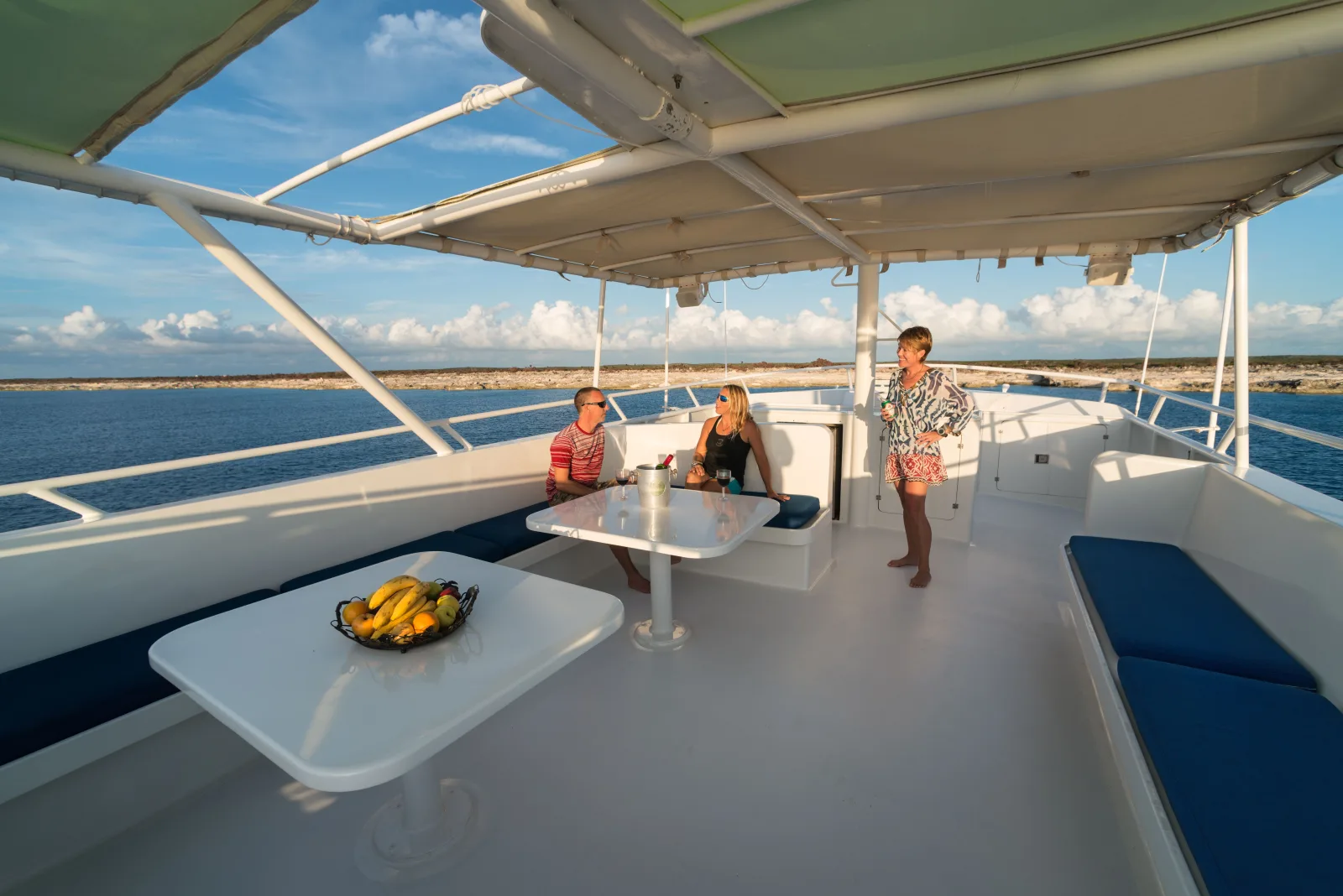 Awning-covered flybridge with settees and tables on Turks & Caicos Explorer II