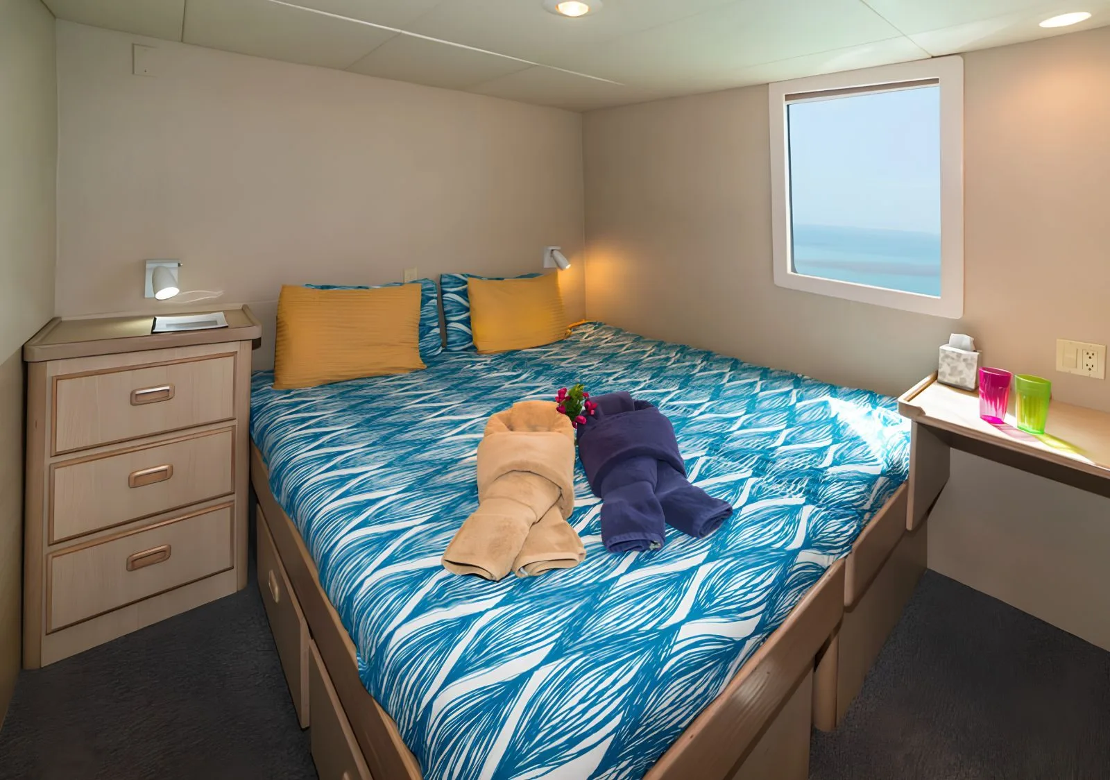 VIP stateroom on Turks & Caicos Explorer II — queen bed and ocean-view window