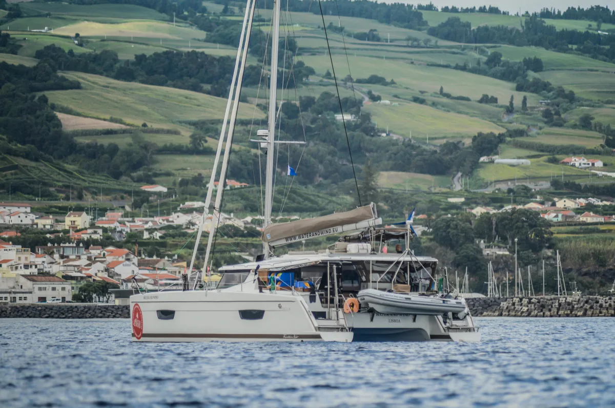 Water and Wind catamaran anchored off the green coast of the Azores