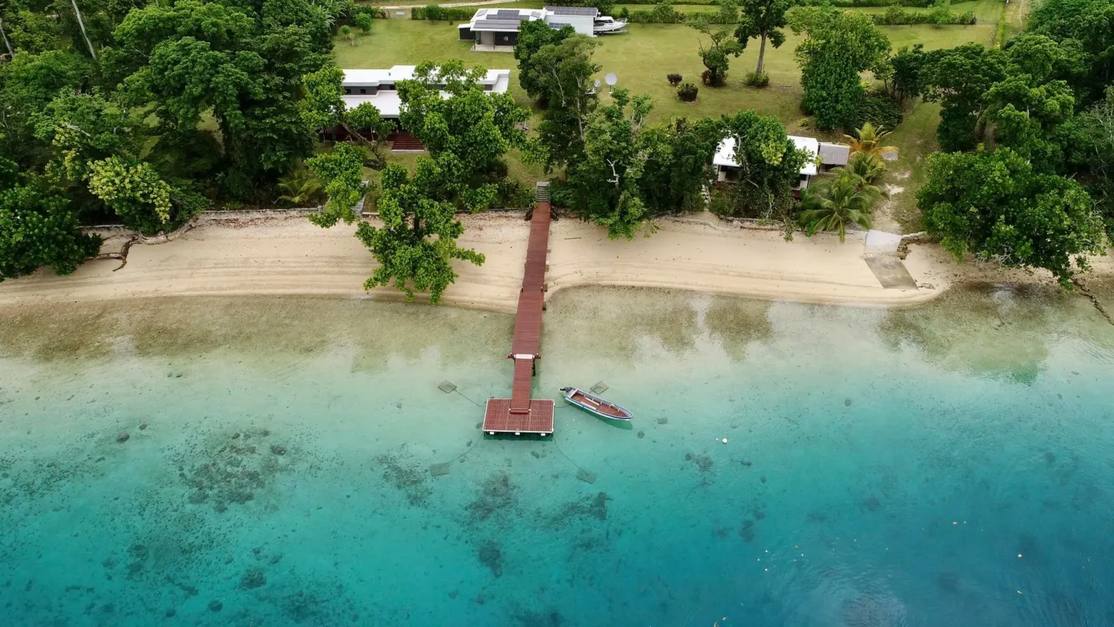 Aerial view of the house, jetty and beach on Aore Island