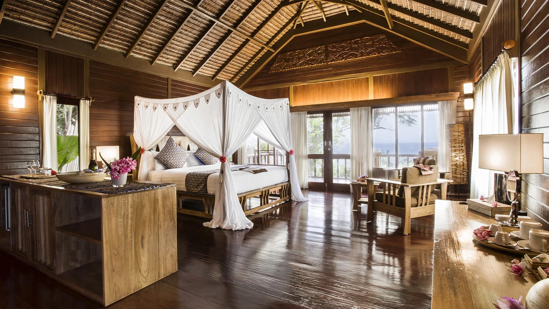 Interior of a Bunaken Oasis cottage with a four-poster bed