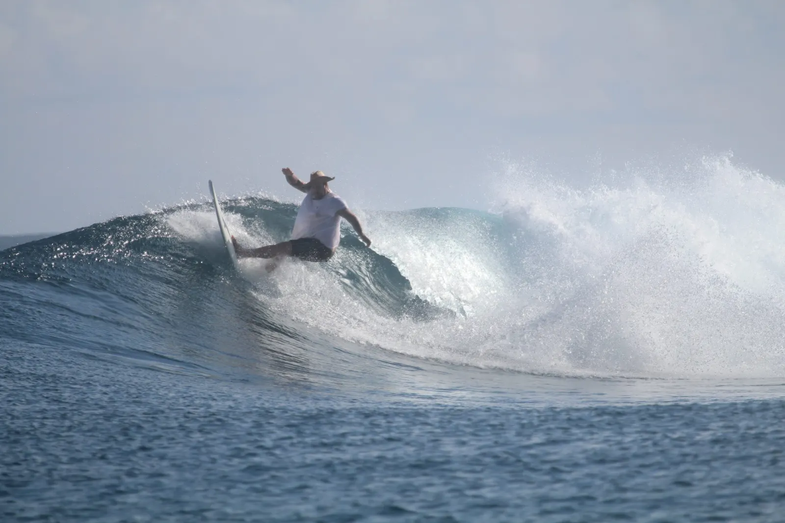 A surfer on a wave off Gizo