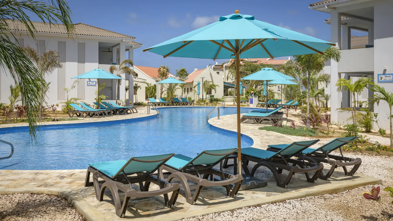 The pool and umbrellas by the wing