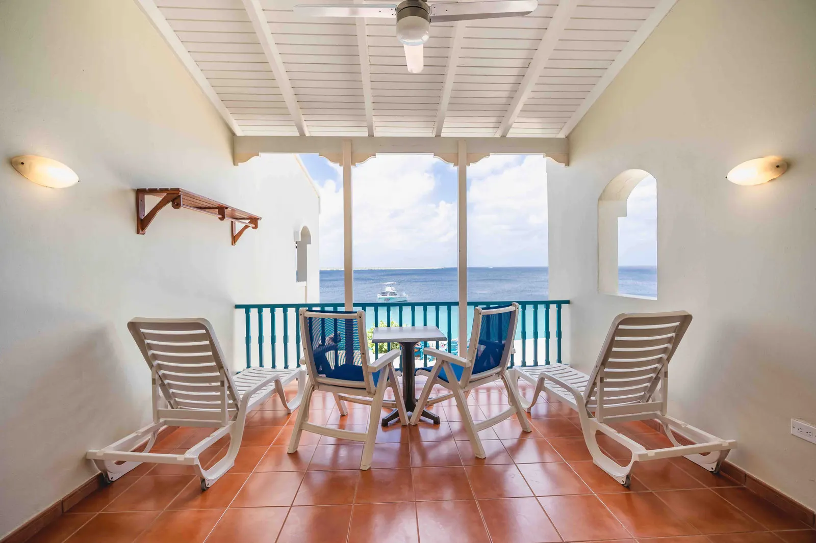A balcony with a table and a sea view
