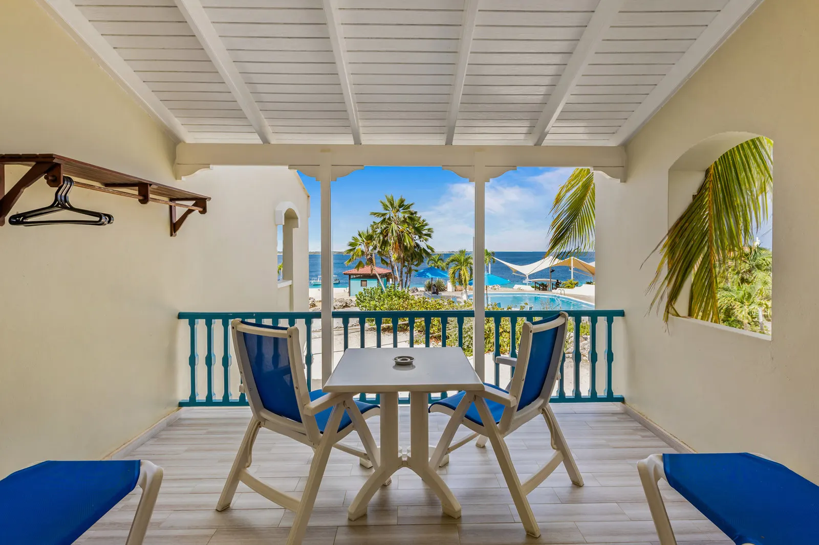 A veranda with a table and a sea view