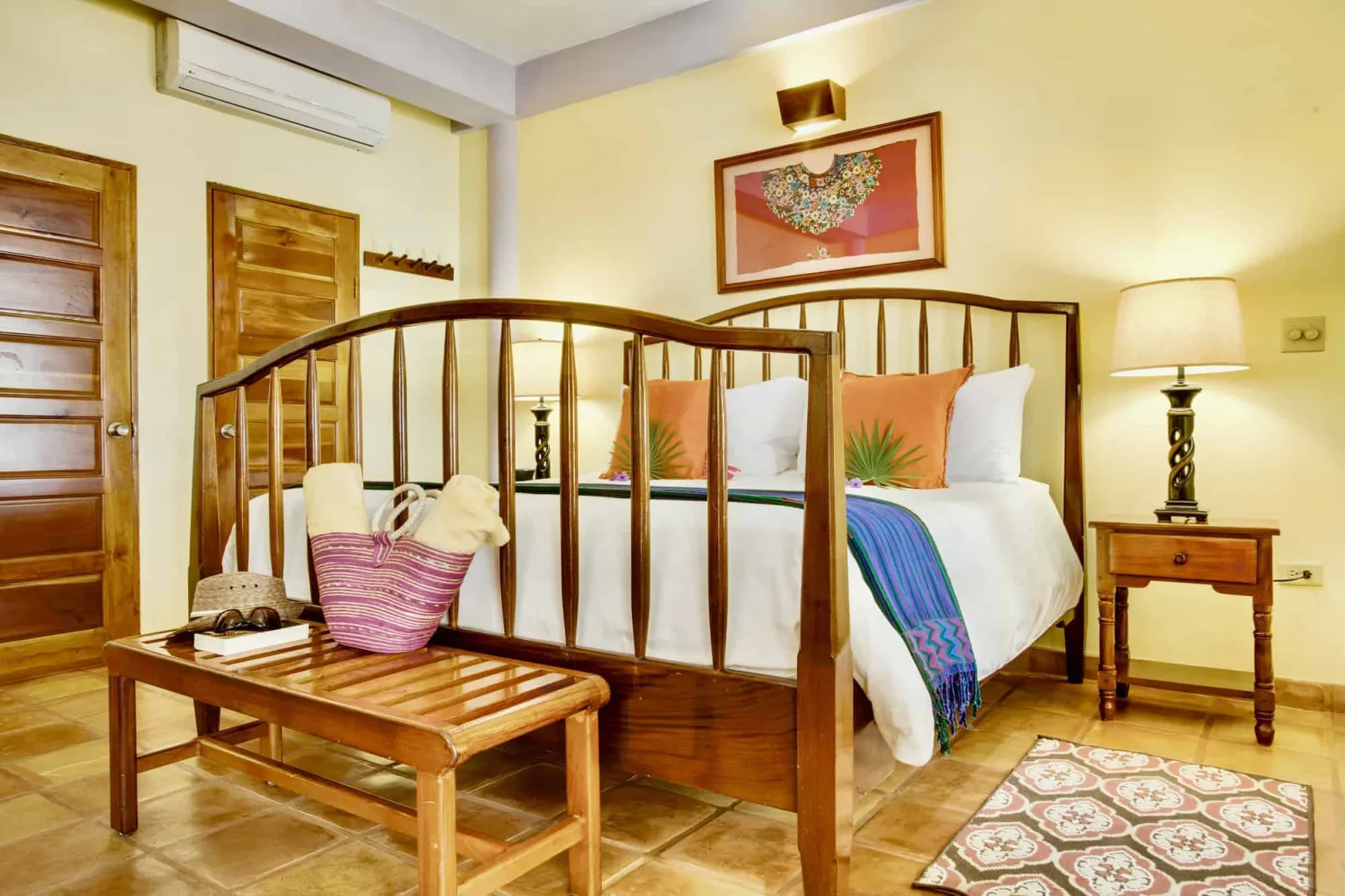 Room with a king bed and a wooden bench