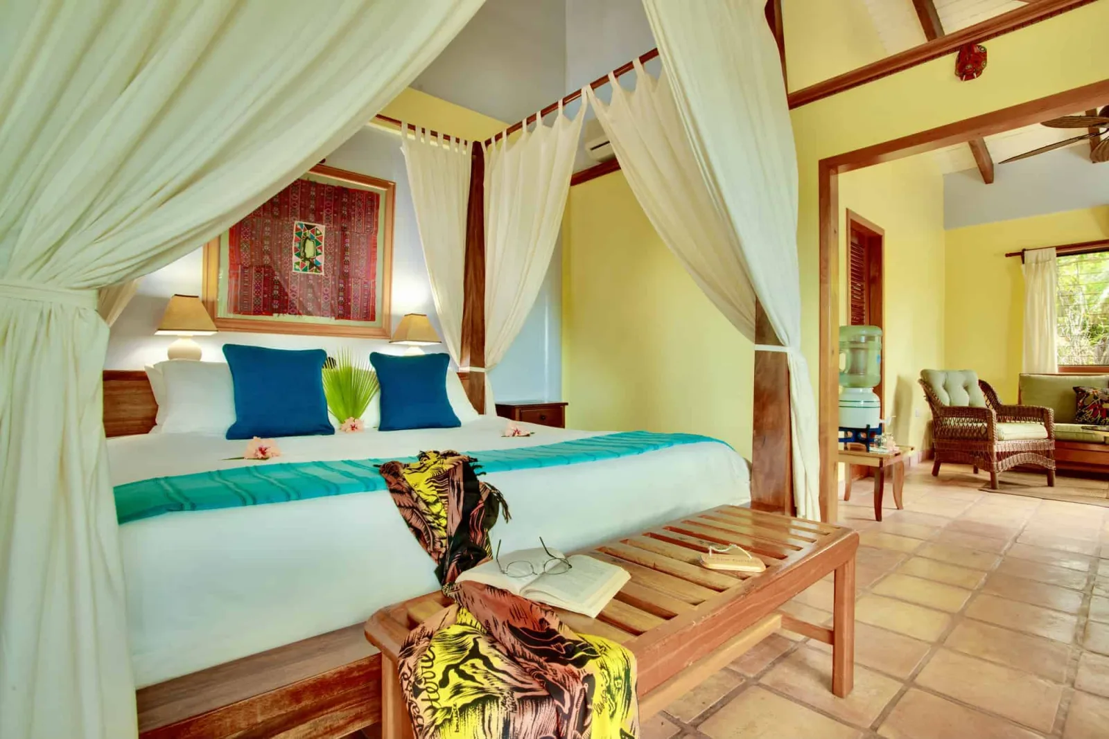 Four-poster bed with light drapes in the suite