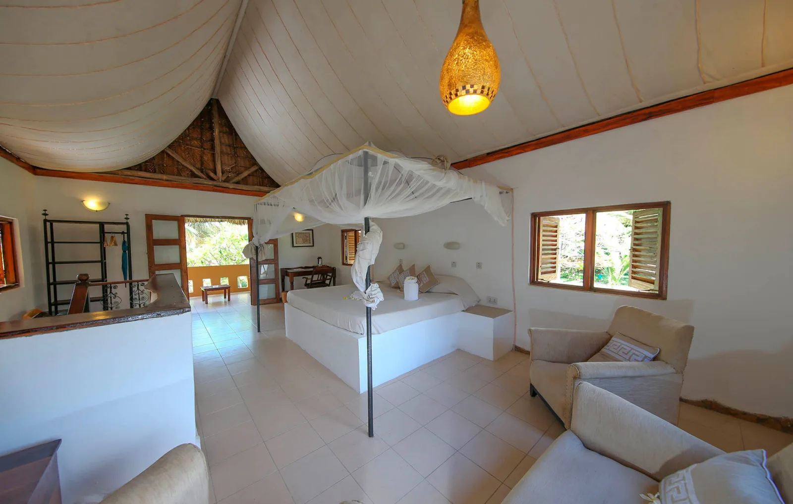 The suite bedroom under a high ceiling with a canopy