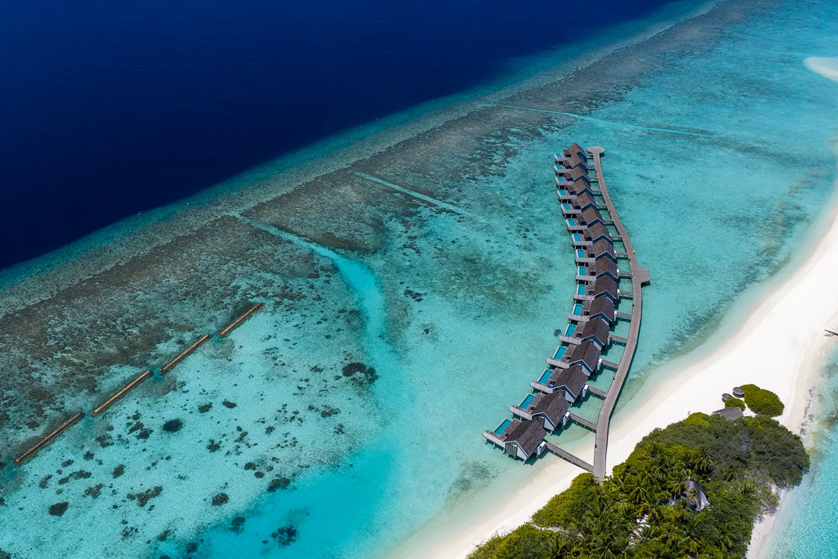 Водные виллы вдоль песчаной косы с высоты