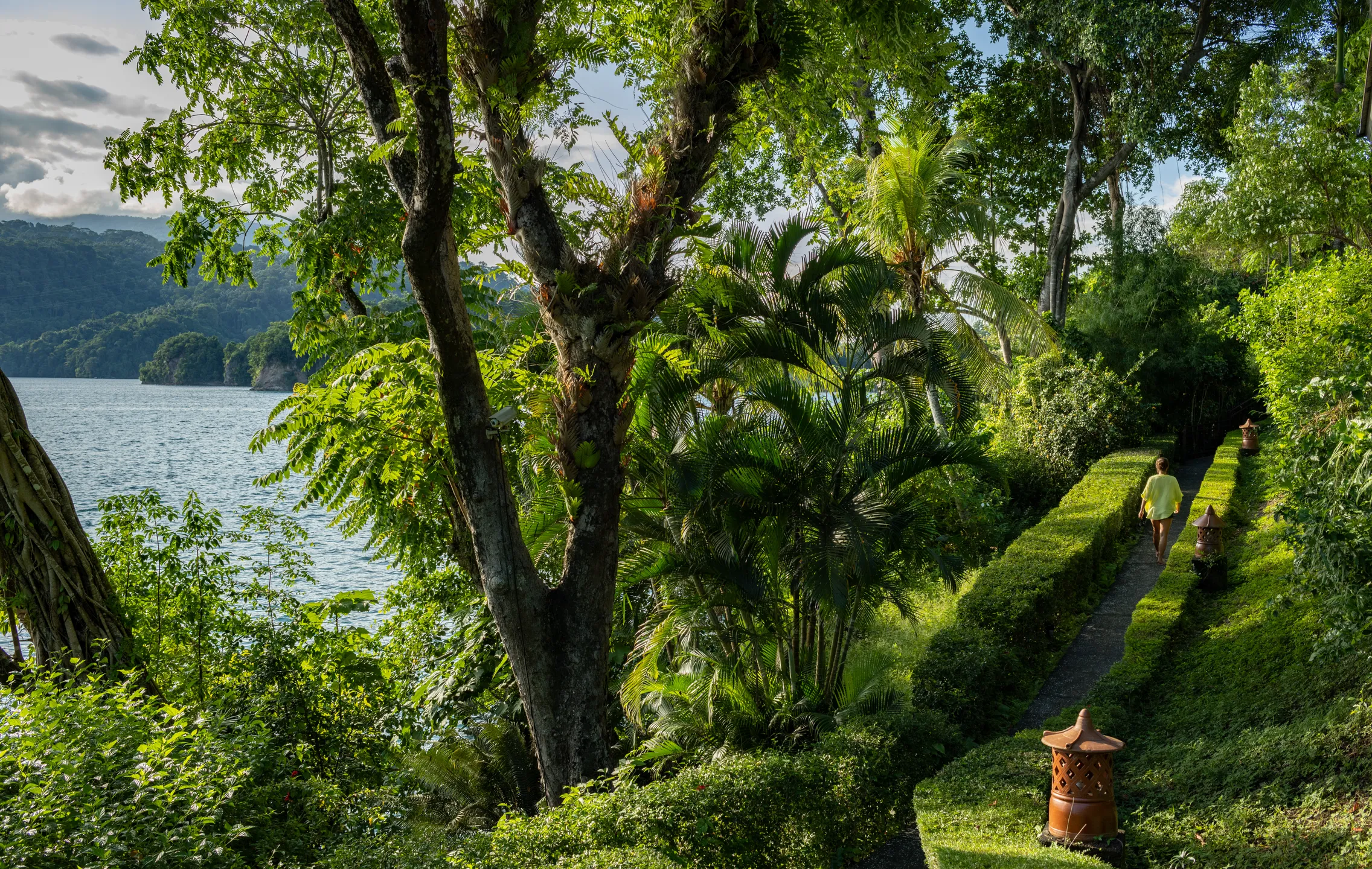Garden path running along the shore through the resort