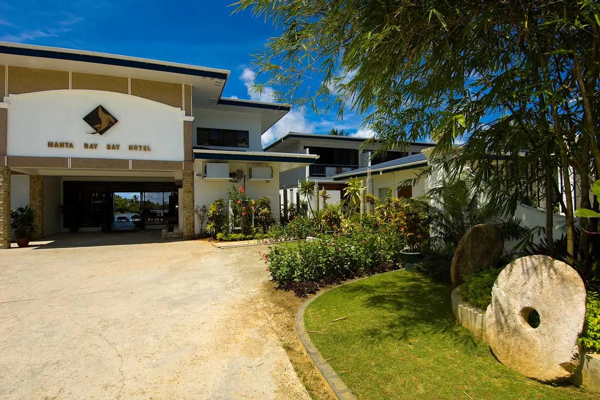 The hotel entrance and stone money by the drive