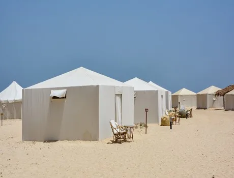 Royal tents on the sand by the water
