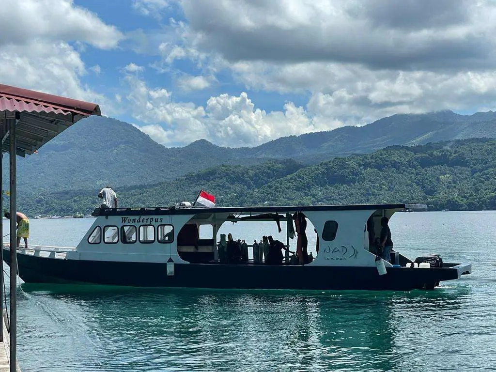 A dive boat against the hills
