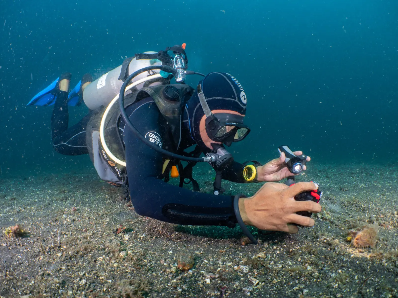 A diver with a camera housing at the surface