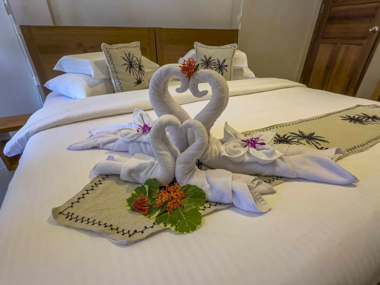 Bed made up with towel swans
