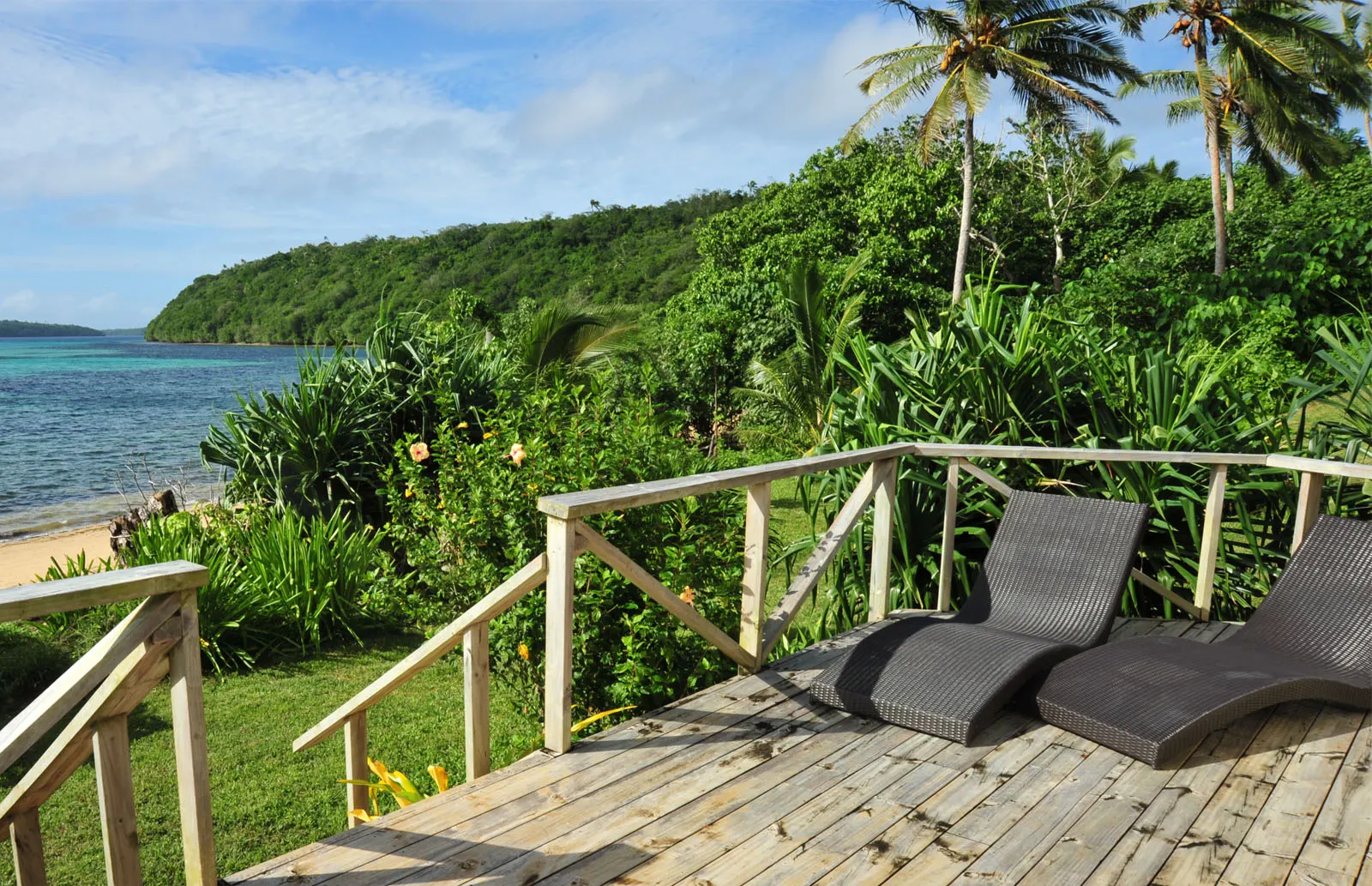 Deck with sun loungers by the beach